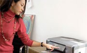 woman pushing the print button on an HP printer