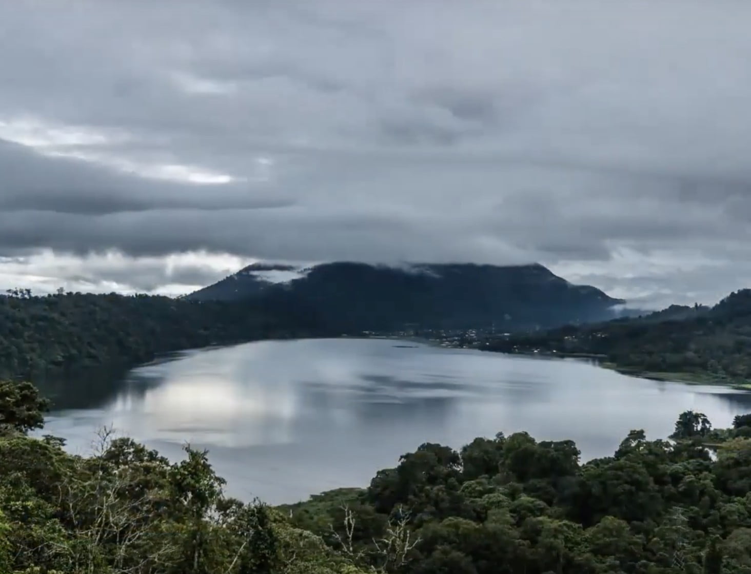 Image of  lake surrounded by mountains.