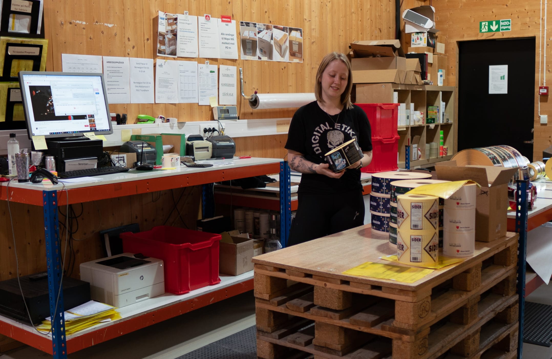 A person standing in a room with pallets