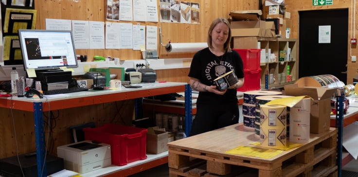 A person standing in a room with pallets