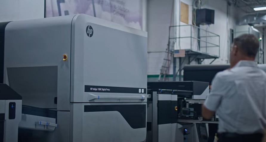 A person working in a factory with an HP Indigo 100K