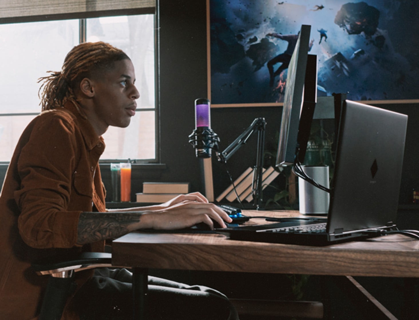 Man sitting at a desk using a microphone and HP desktop gaming PC