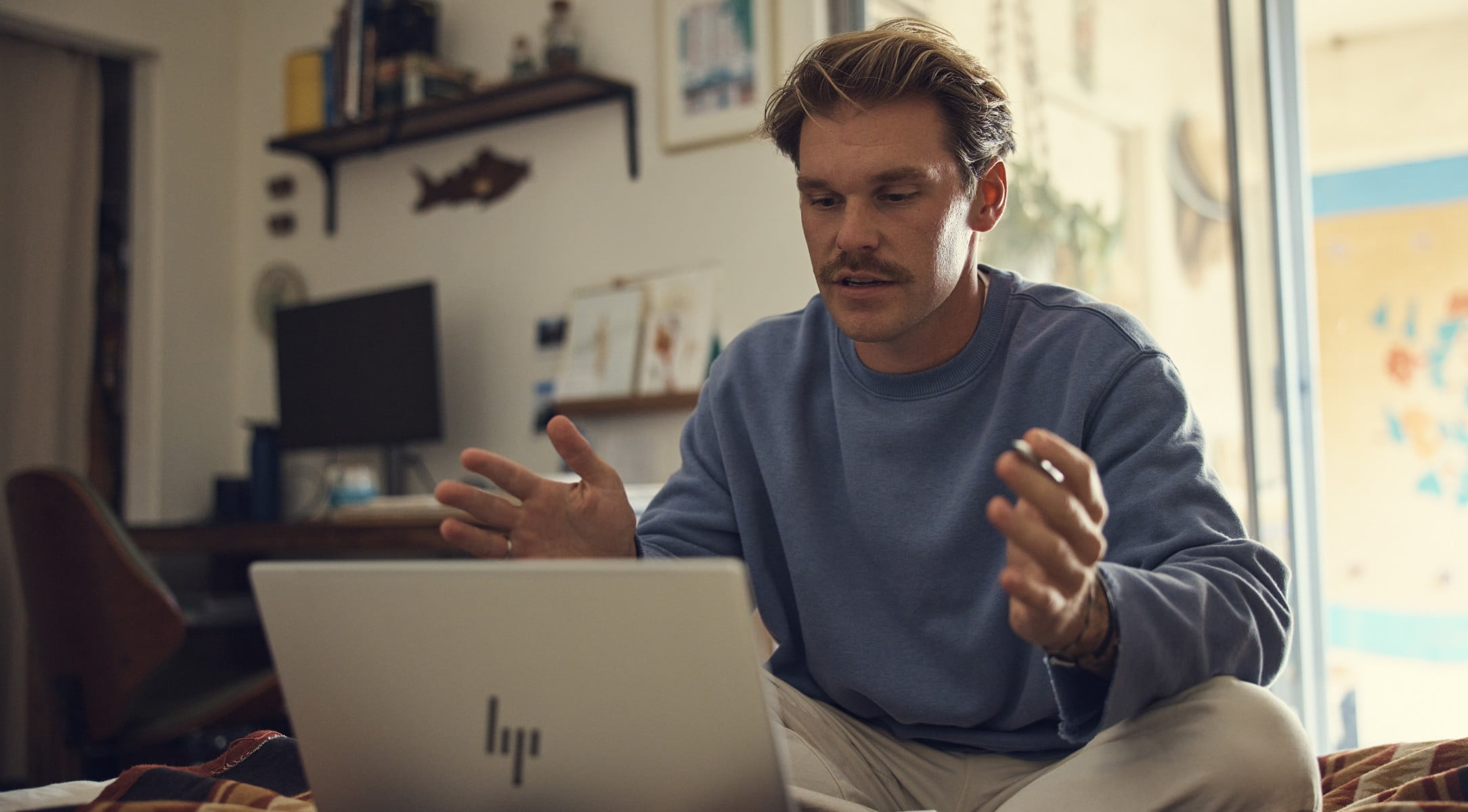 Man having a virtual conference on his HP laptop.