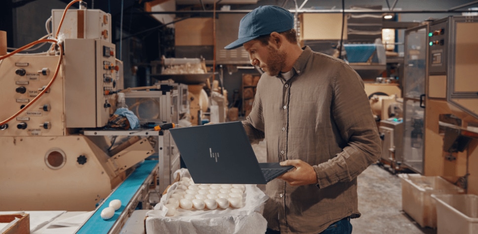 Man using HP laptop in a factory