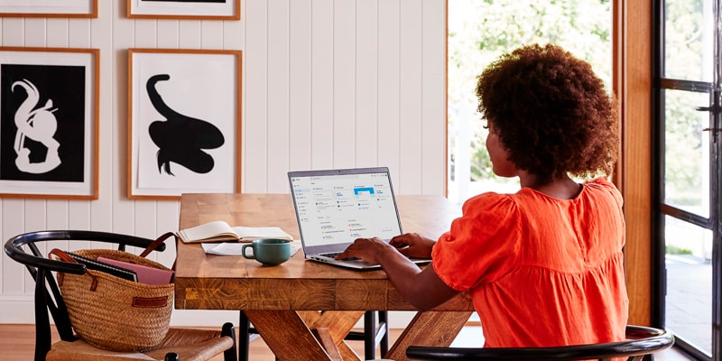 A woman sitting in her living room using an HP laptop.