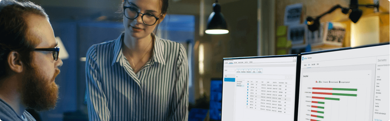 A woman sharing some information to her co-worker on his two HP monitors.