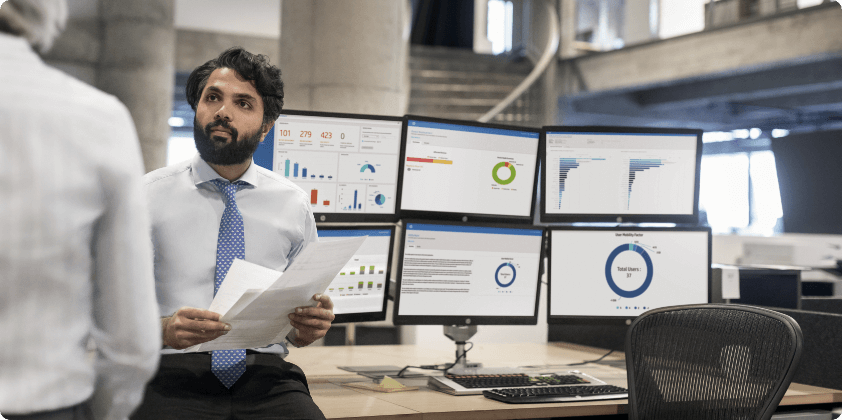 Two man working with some data sheets in six HP monitors.