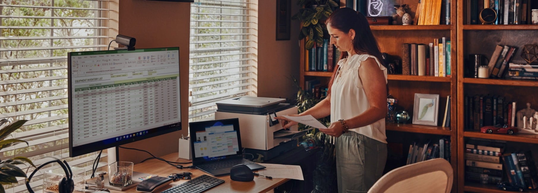 A woman printing wirelessly some data on an HP printer from her HP laptop.