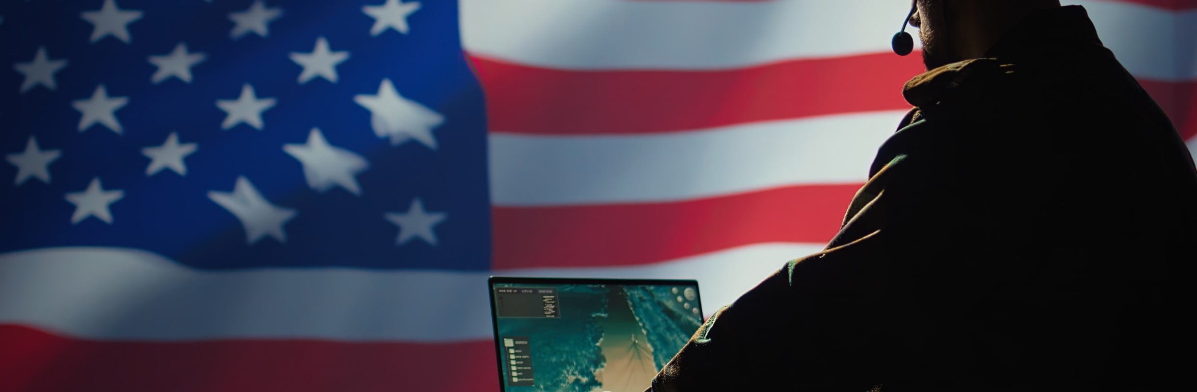 Man using HP notebook in front of the American flag