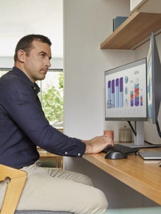 A man working on an HP all-in-one pc connected to an HP monitor