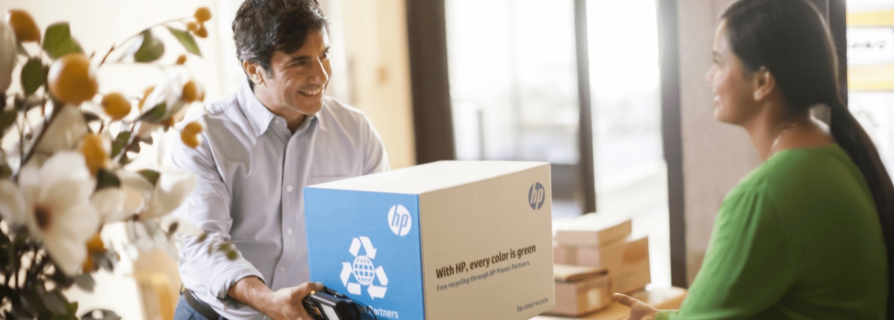 A woman receiving an HP package from a delivery man