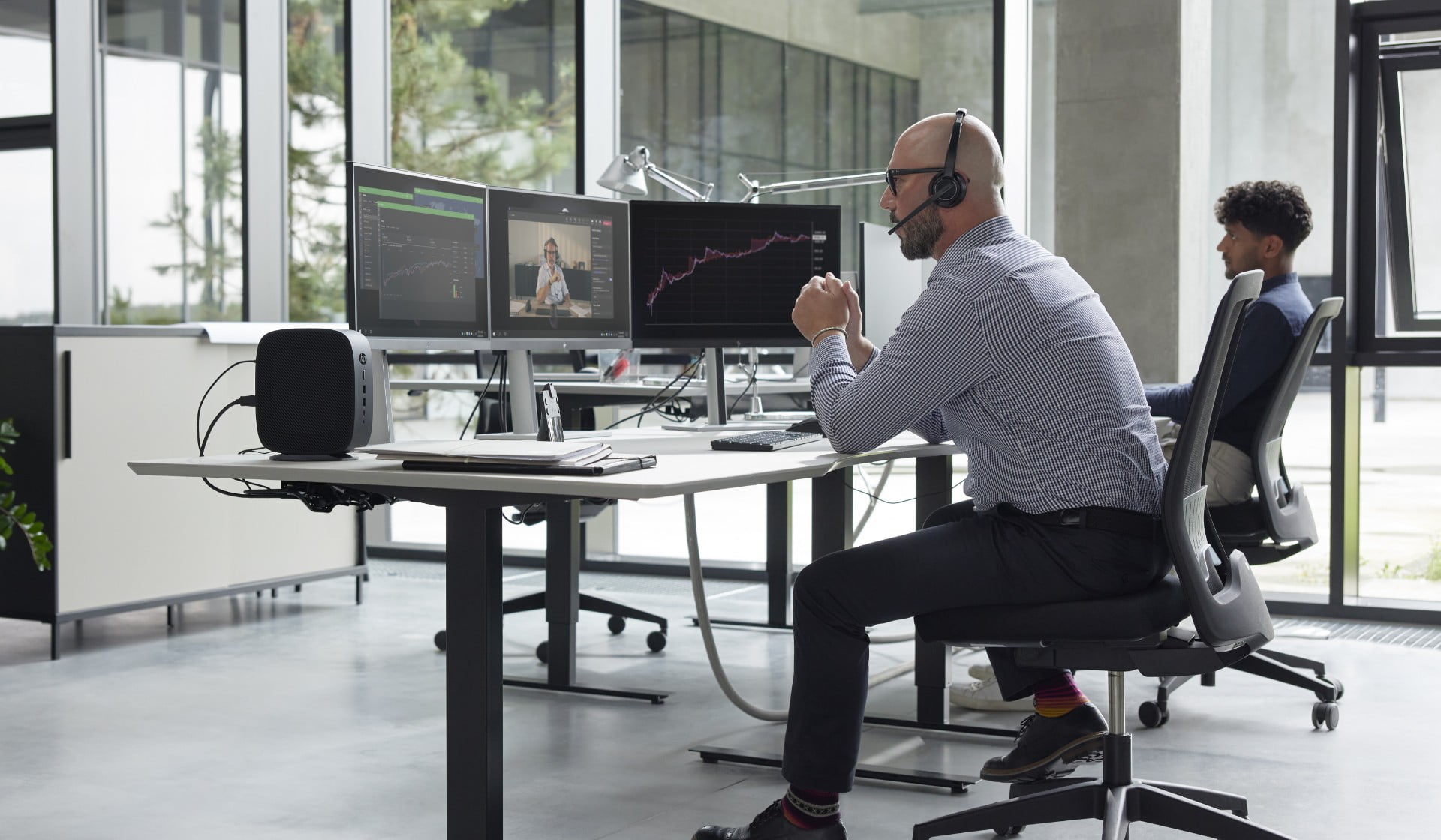 Man working in front of an HP computer.	