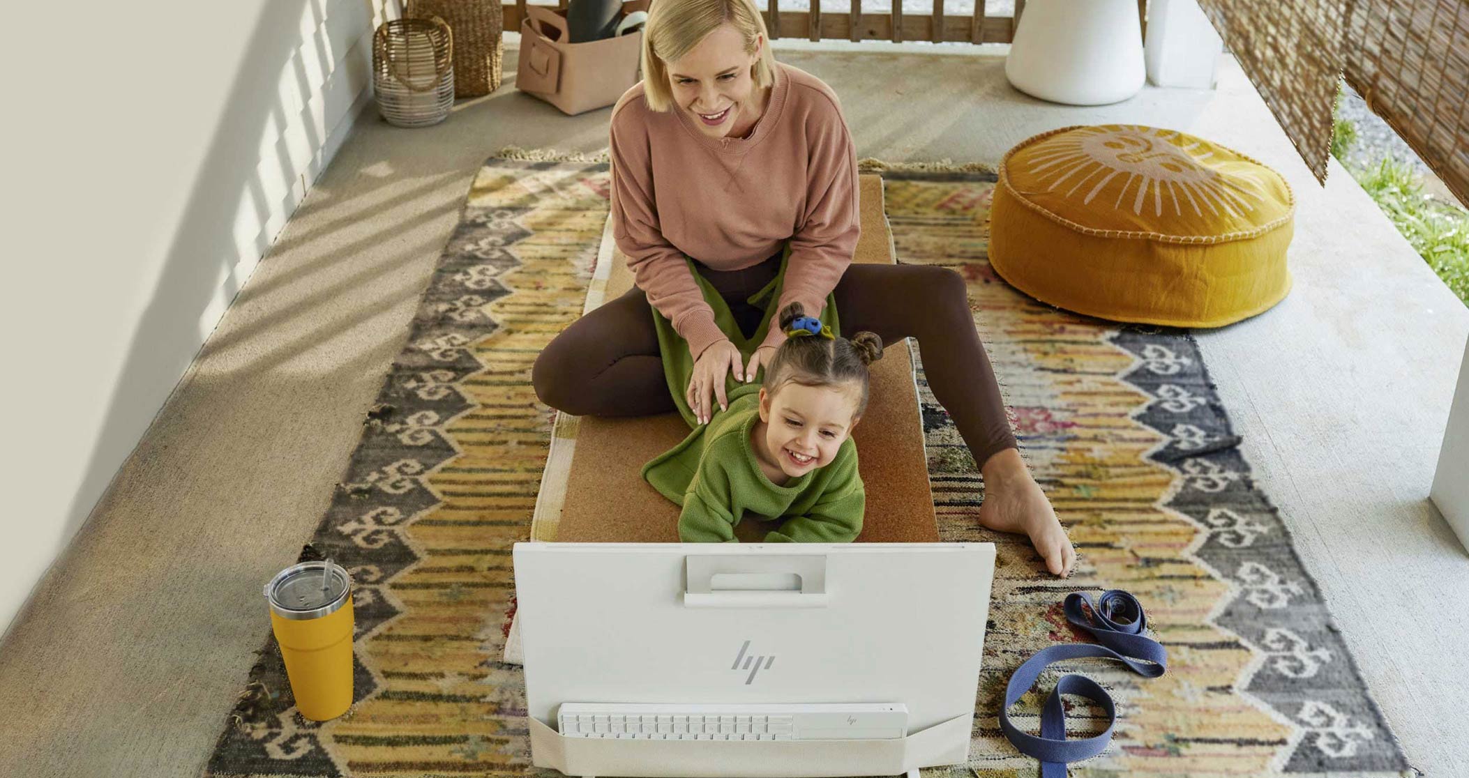 a mother with her daughter watching an hp desktop