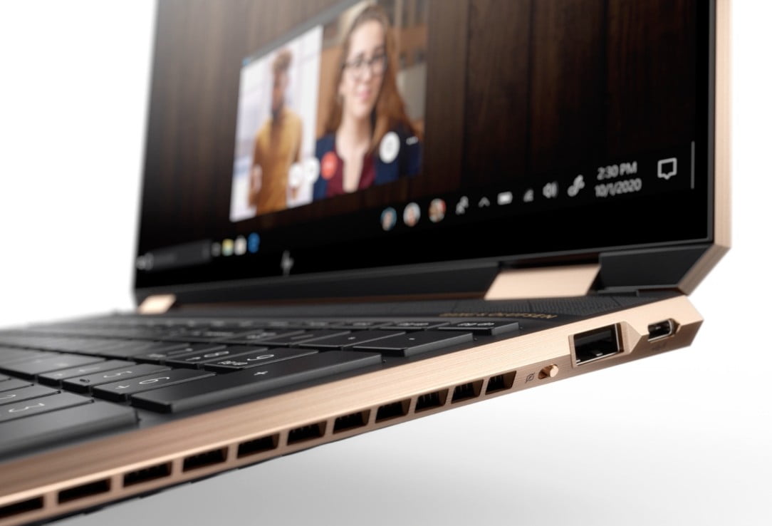 An HP Spectre laptop on a side view close up, showing a virtual meeting in the screen.