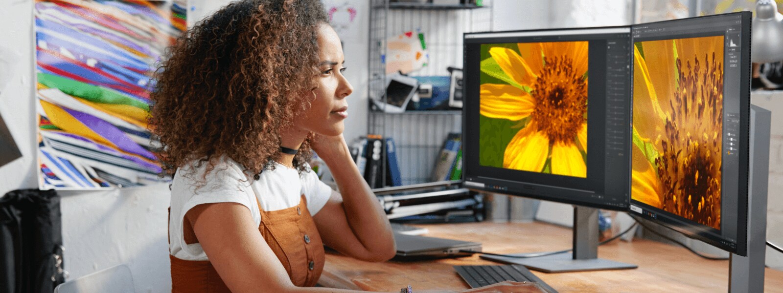 Woman designing in front of two HP Monitors