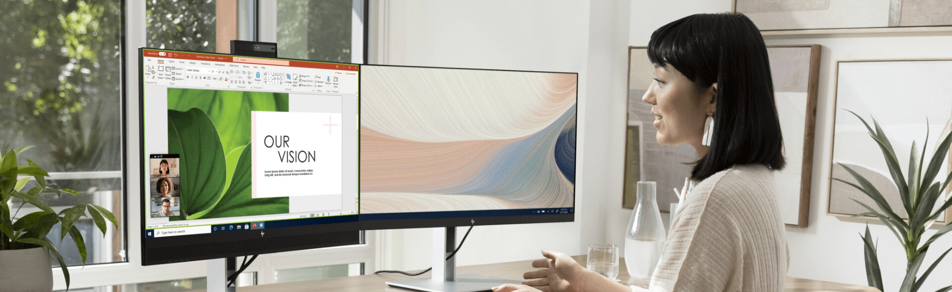 A woman having a virtual conference on her two HP monitors.