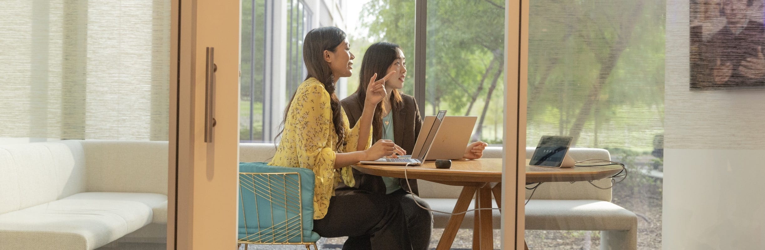 Two women with laptops on a video conferencing call