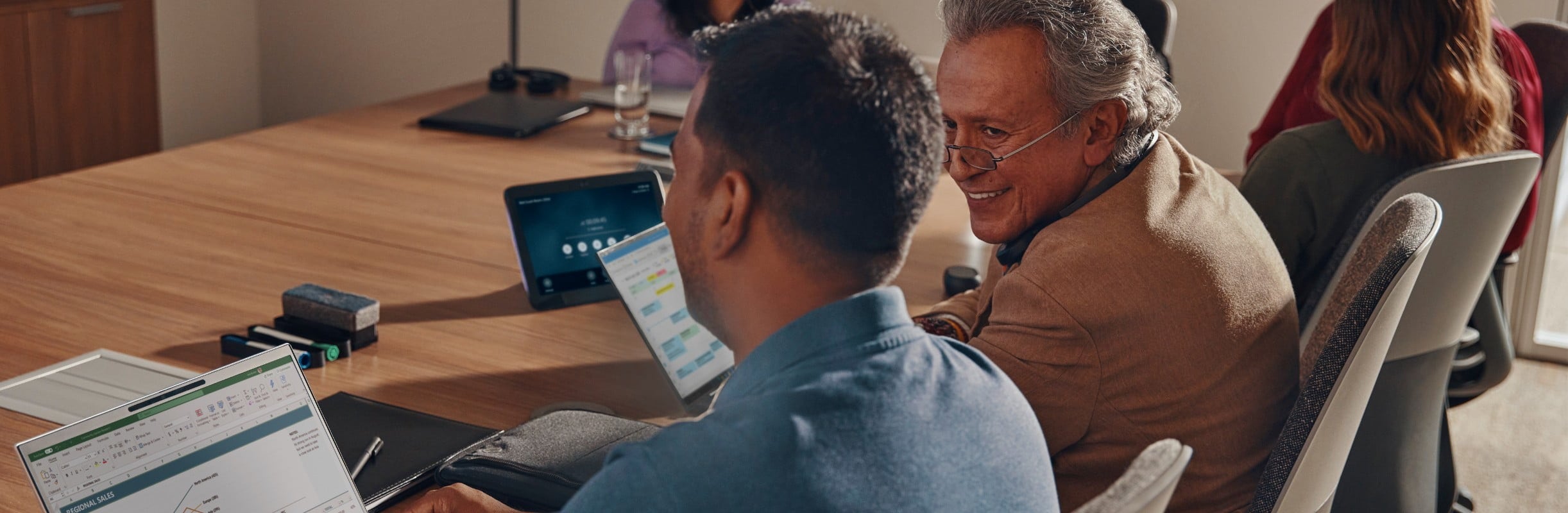 Employees in a meeting with laptops