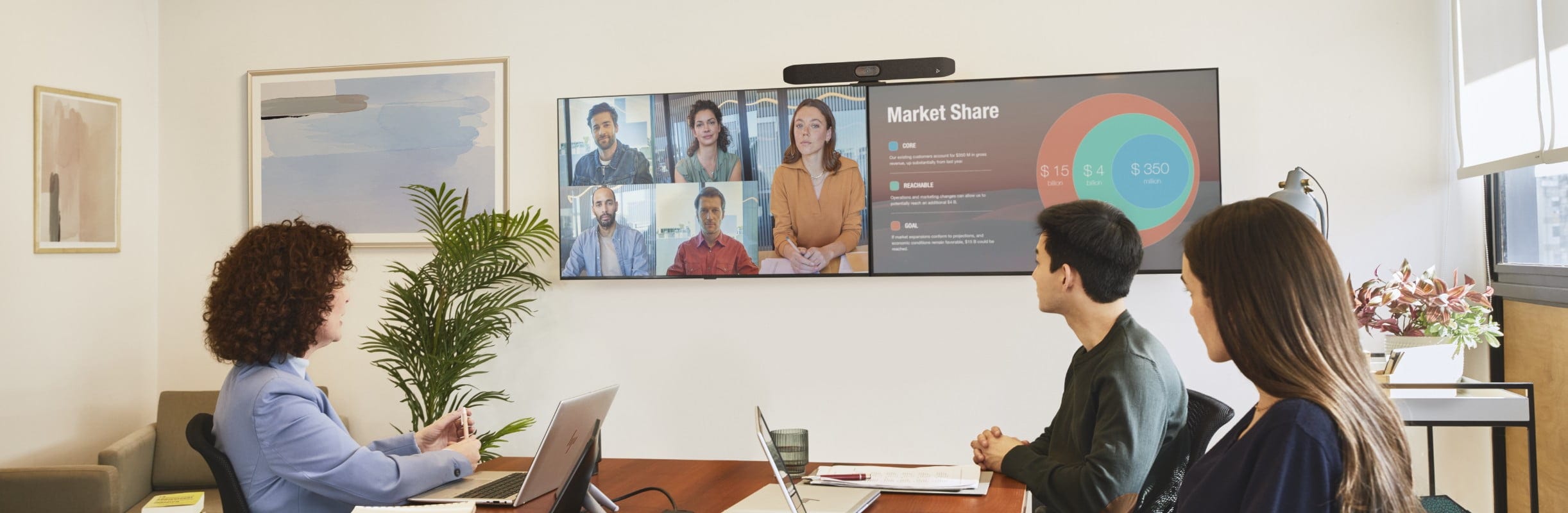 Two people in a meeting room on a video conferencing call