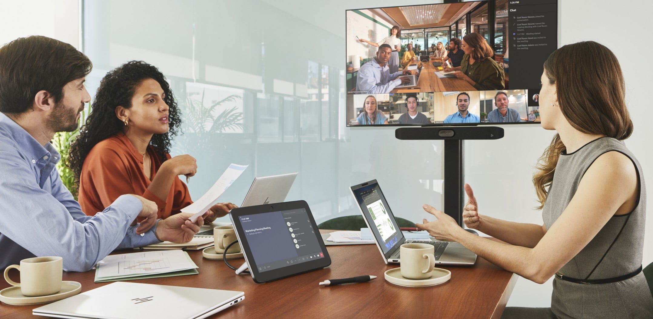 People in a meeting room on a video conference call