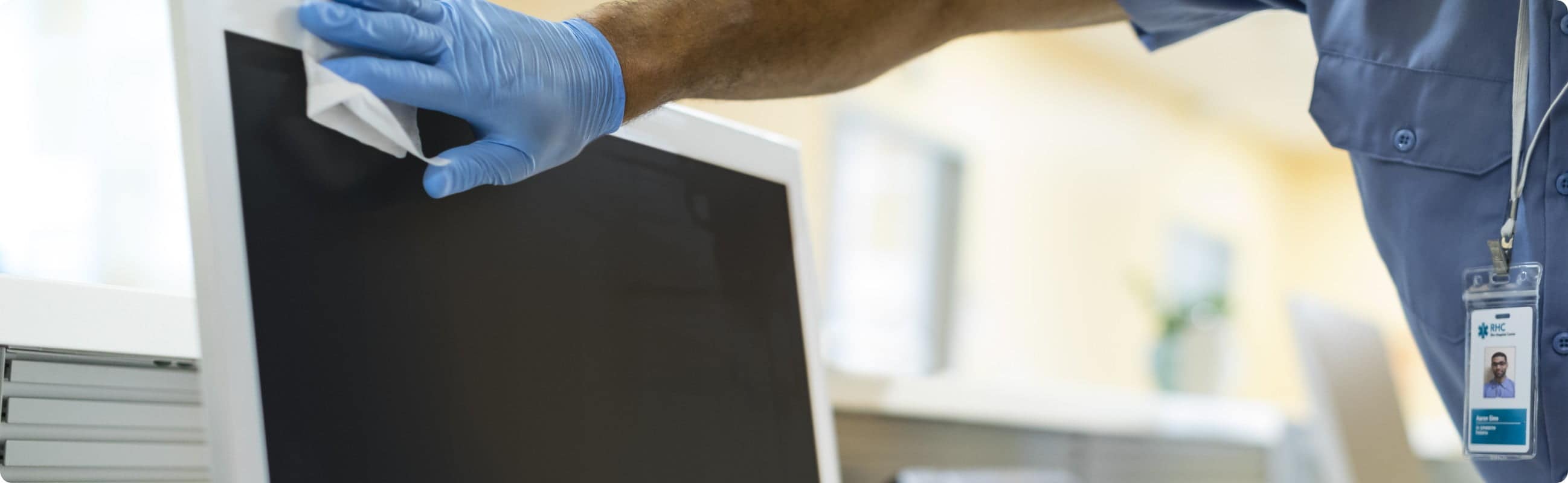 Man disinfecting a monitor