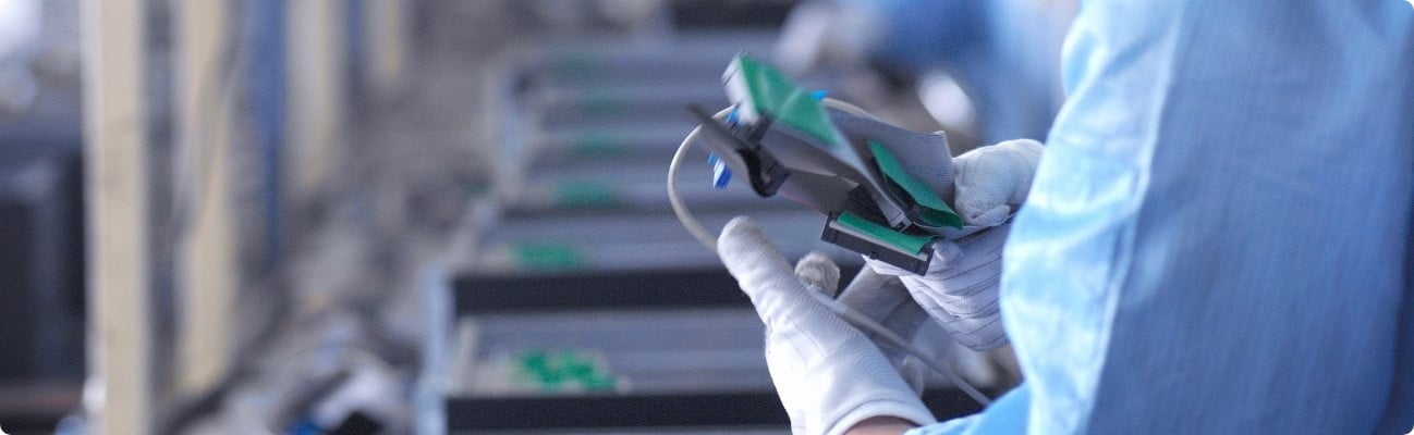 Electronic factory worker is testing a computer component