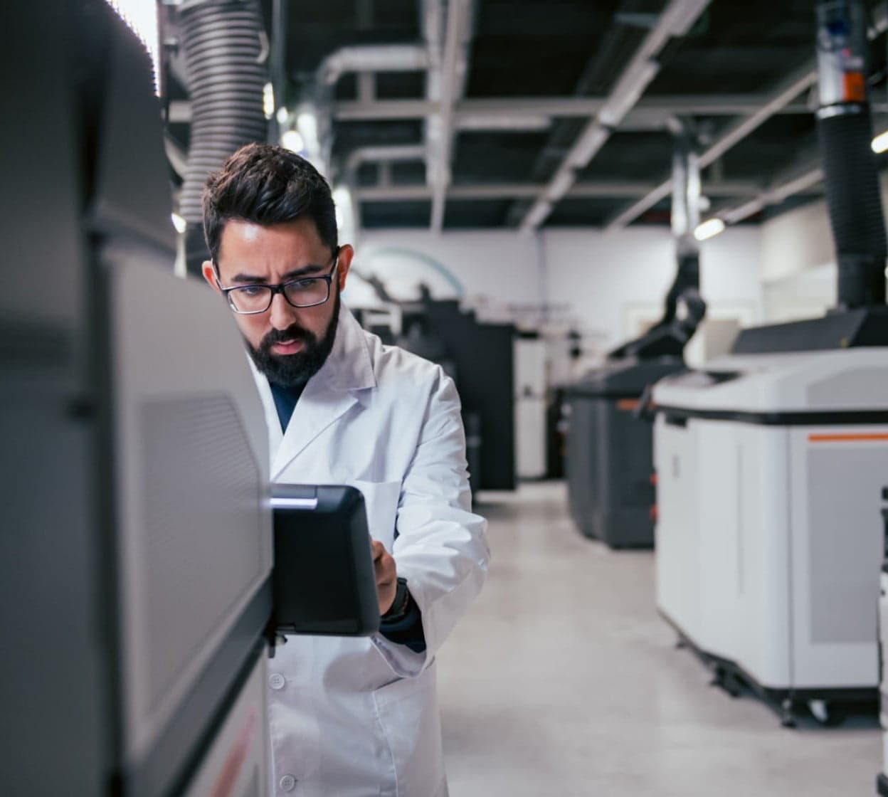 3D engineer repairing an industrial 3d printer