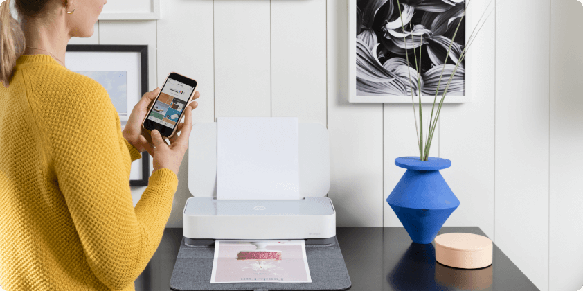 Woman sing HP Smart app to print at home on Tango printer