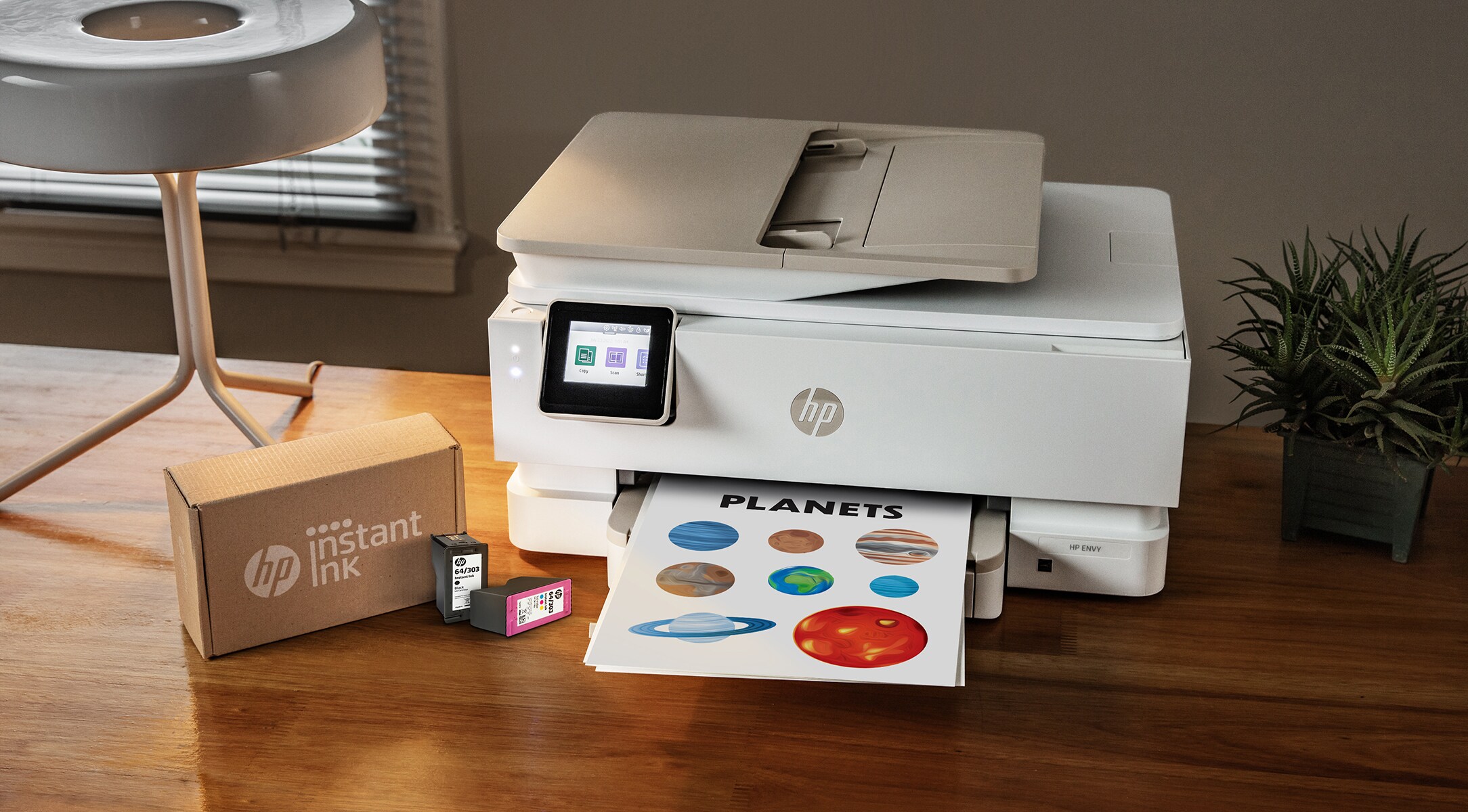 HP Instant Ink box next to HP ENVY Printer