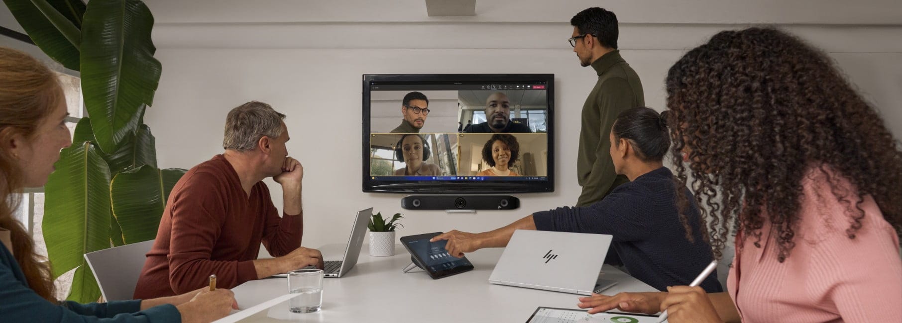 People sitting in a boardroom, having a video conference.