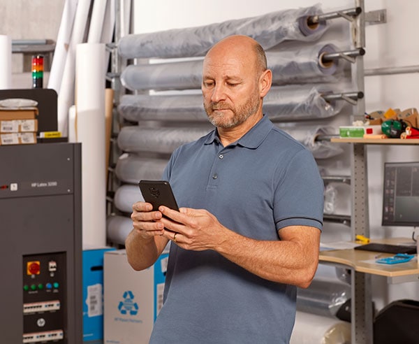 Person working on a mobile device in a copyshop