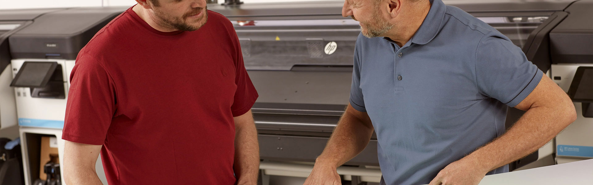 People in workplace setting standing in front of HP Latex 700 Printer series