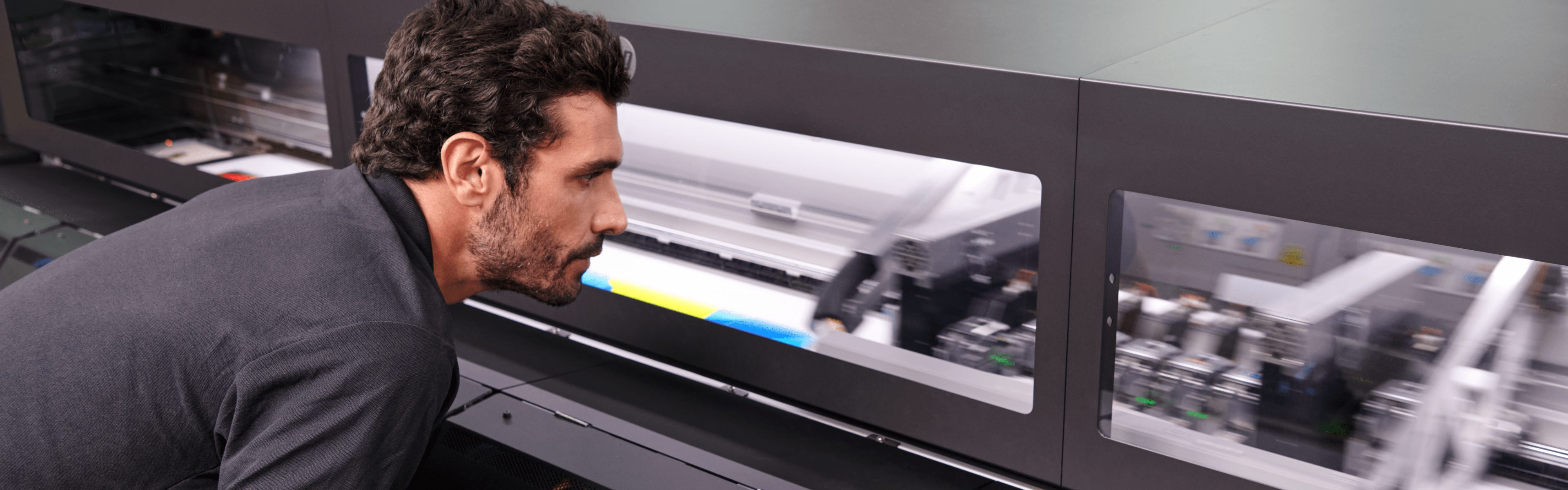 Person examining an HP Latex printer