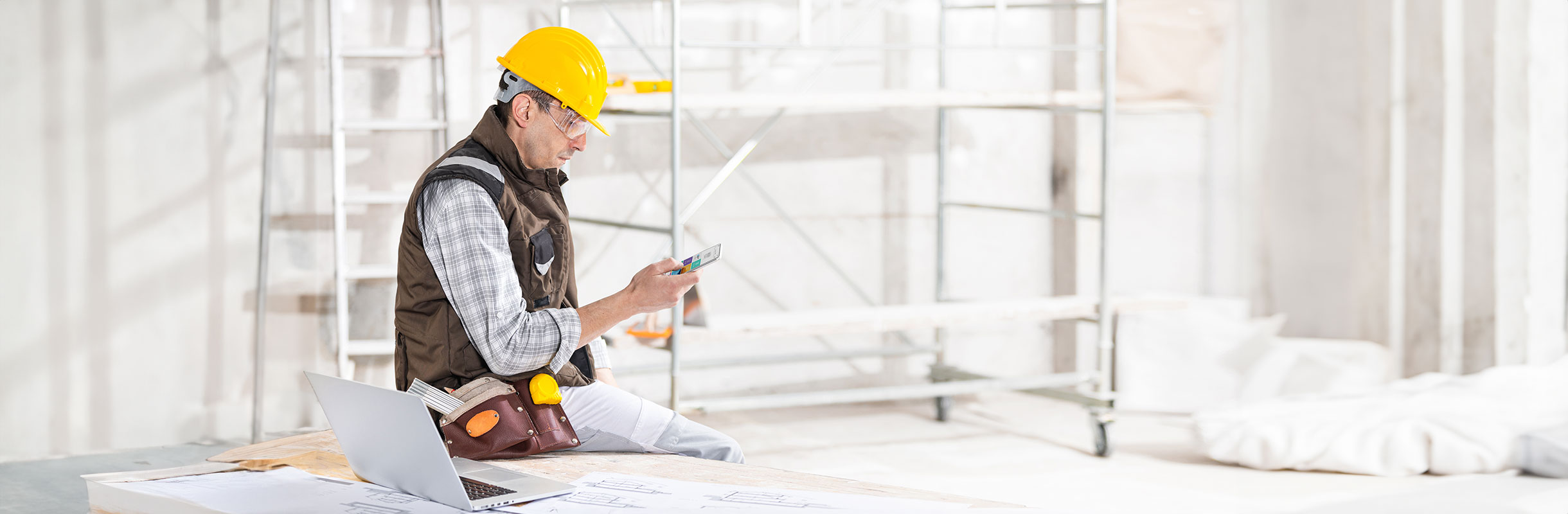 Person using a mobile device inside a construction site