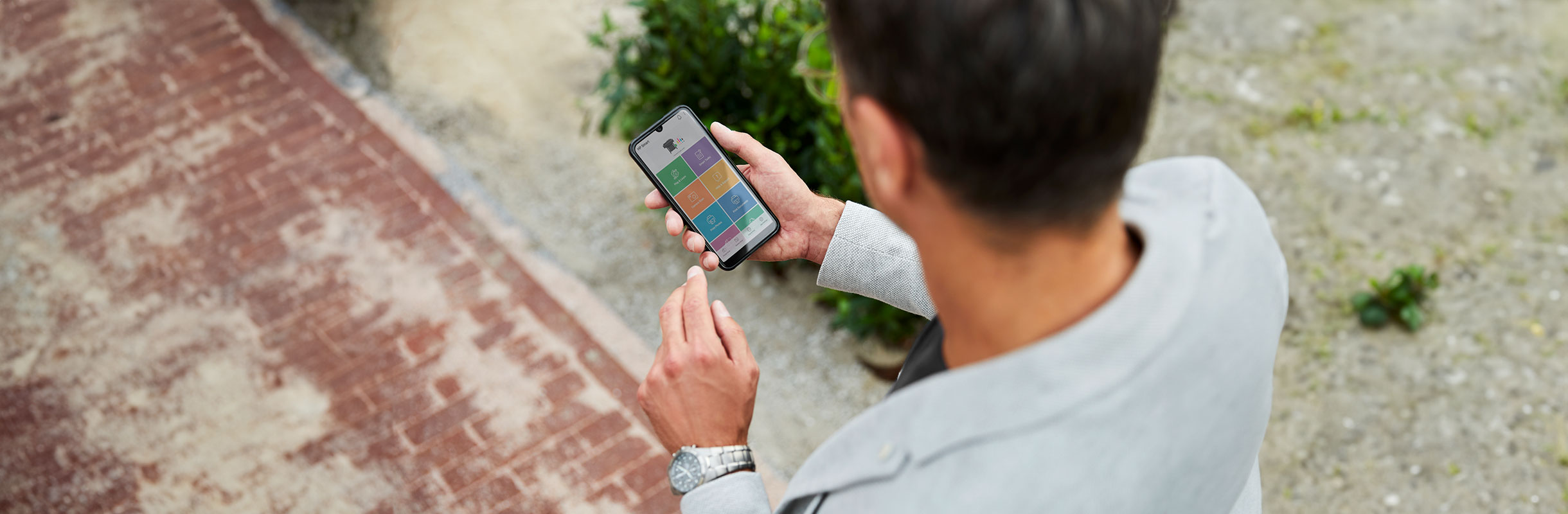 Person checking a mobile device using the HP Smart App