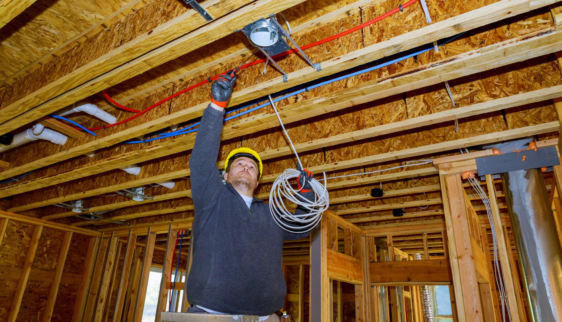 Electrical engineer quickly installing wiring after using an HP SitePrint robot to mark all the locations