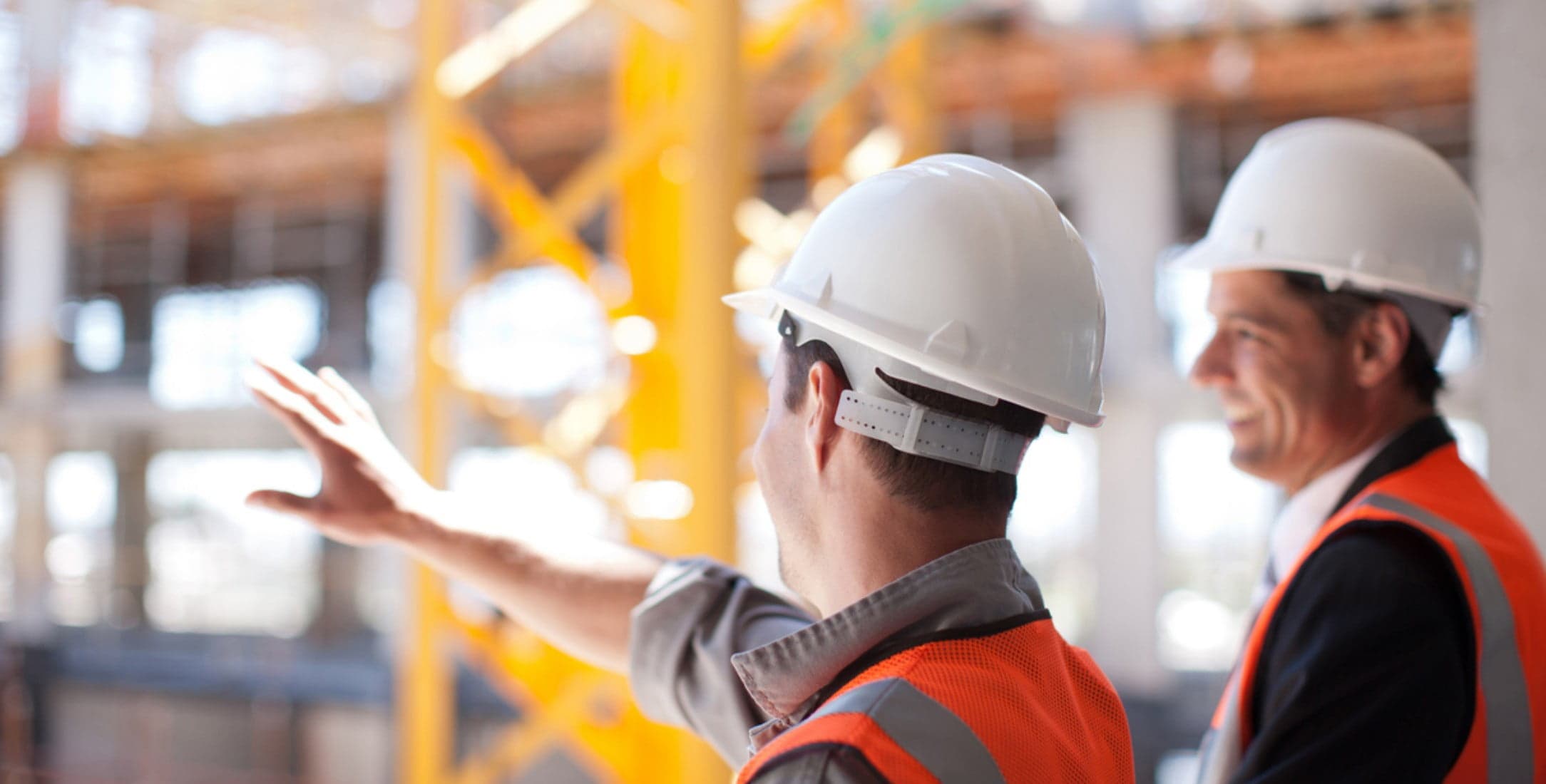 Two construction workers assessing construction site