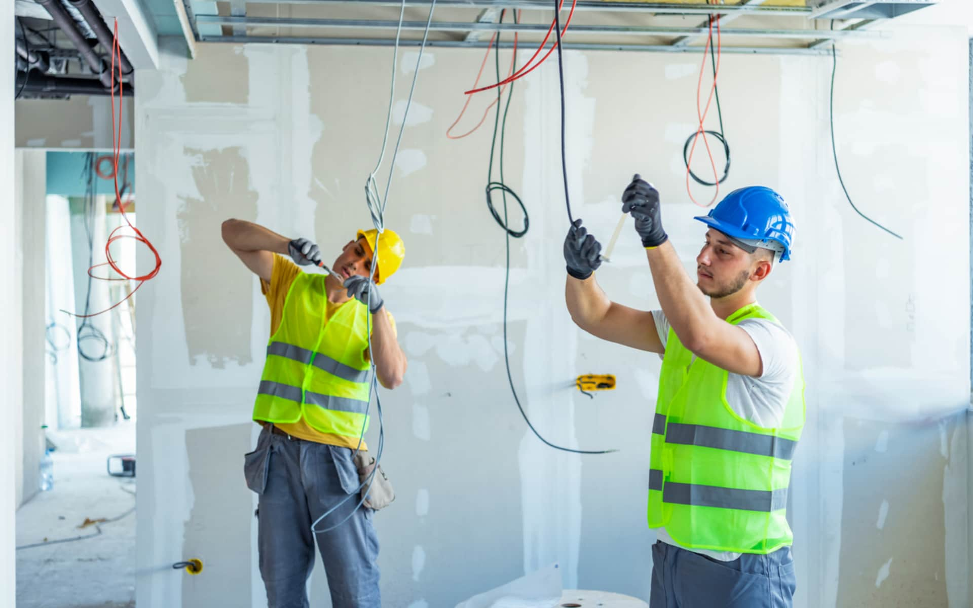 Electricians quickly installing wiring following layout markings from electrical engineering robotics for construction