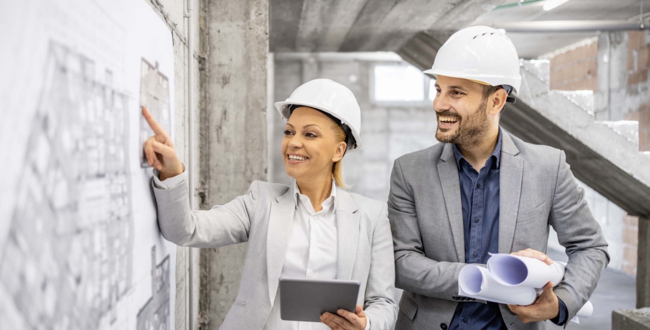 Coworkers discussing the benefits of advanced drywall project solutions for their project