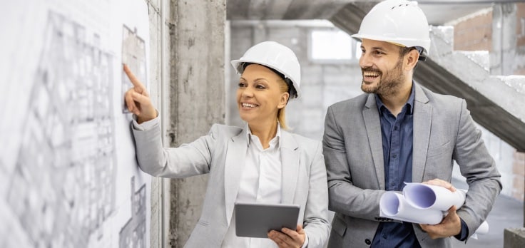 Coworkers discussing the benefits of advanced drywall project solutions for their project