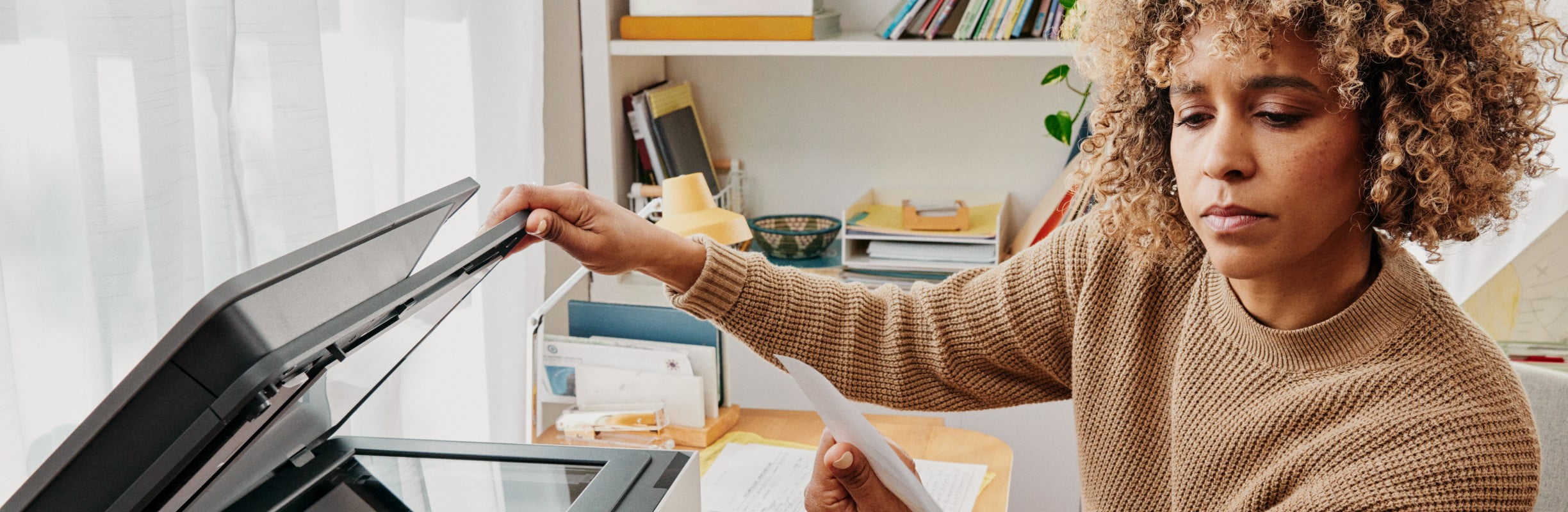 Woman in front of a printer.