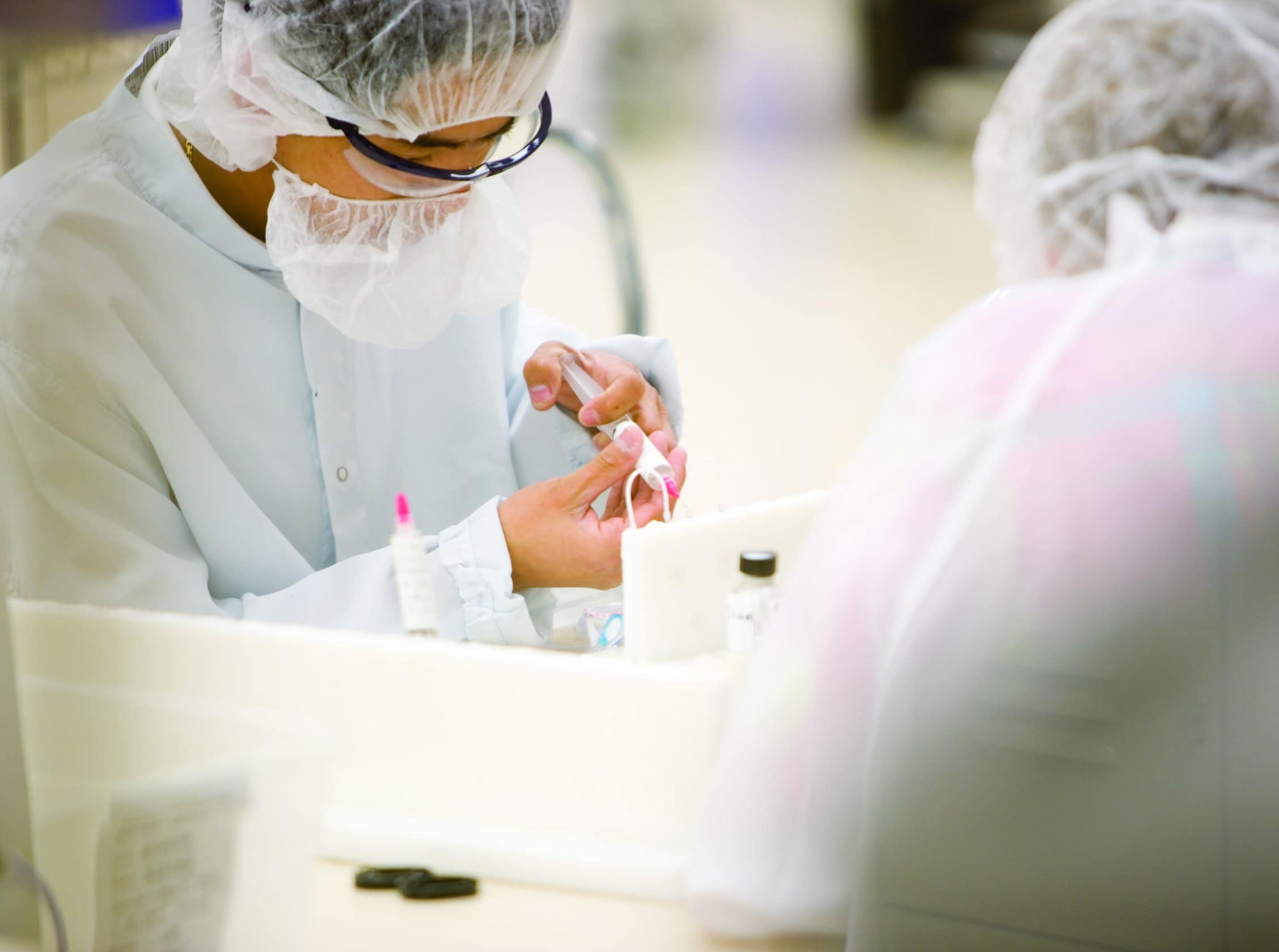 Two manufacturing workers examining product