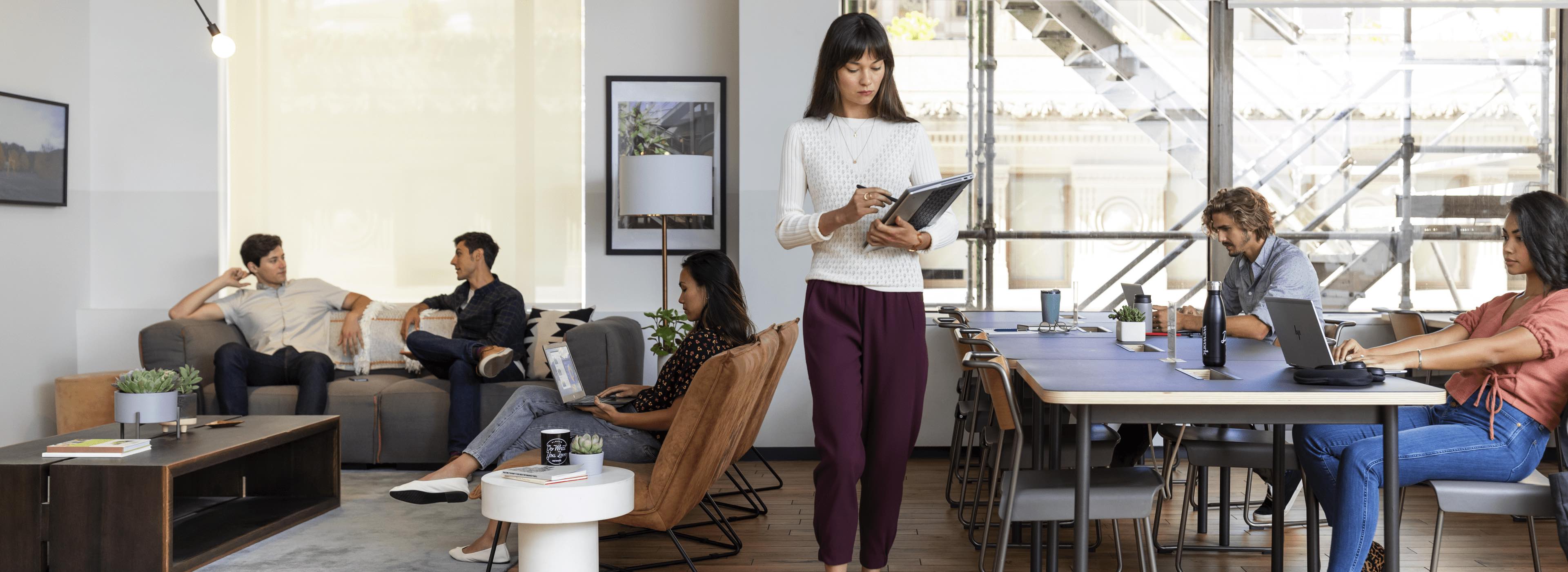 Worker in open office with meeting happening