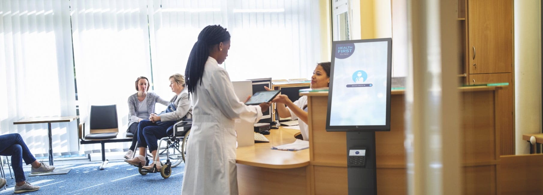 An HP Engage Express system standing near the reception of a medical clinic