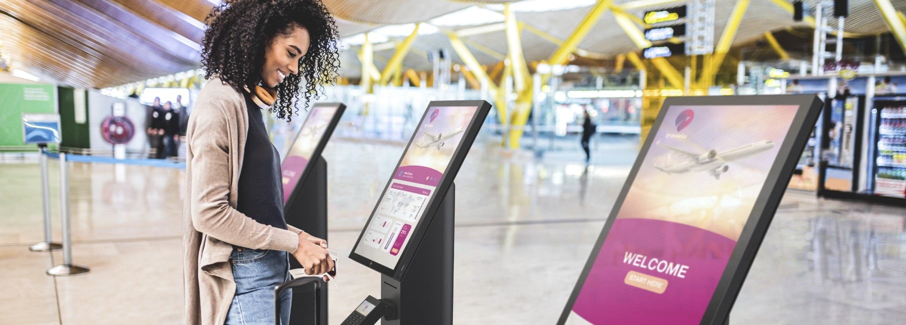 Woman using an HP Engage Express system to obtain a boarding pass at an airport