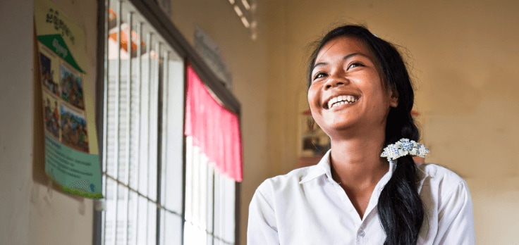 Image of a girl smiling in a classroom