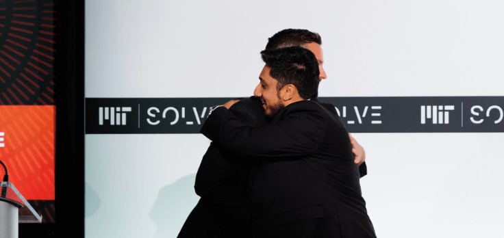 Two men hugging.