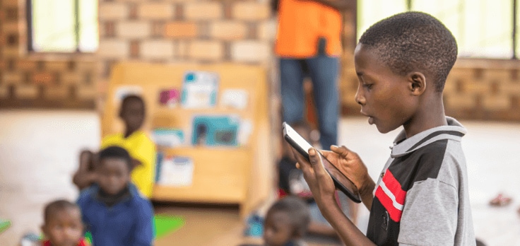 Photo of a child presenting in front of his classroom