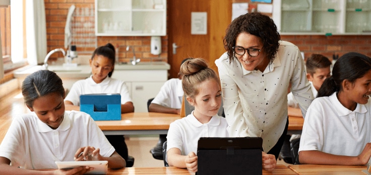 Teacher teaching children in front of their HP computers.