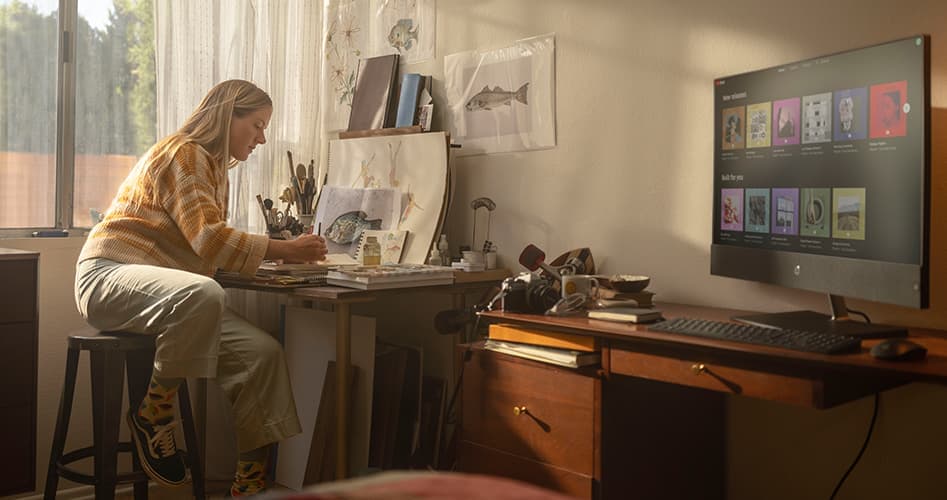 young woman using an HP All-in-one Desktop computer